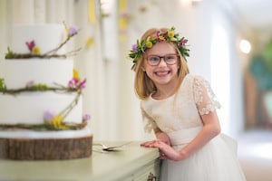 Flower girl and rustic wedding cake