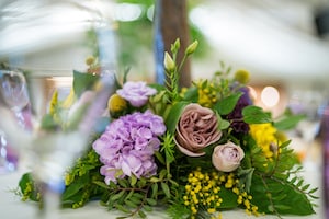 Spring Purple and Yellow Table Centre Flowers at Applewood Hall