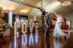 Bride and groom's first dance under the chandeliers at Applewood Hall
